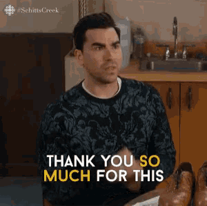 a man is sitting at a table with a pair of shoes and says thank you so much for this
