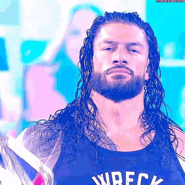 a man with long hair and a beard is wearing a wreck tank top