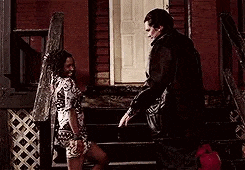 a man and a woman are standing next to each other on the stairs .