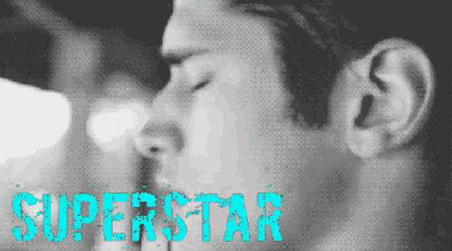 a close up of a man 's face with the word superstar in blue