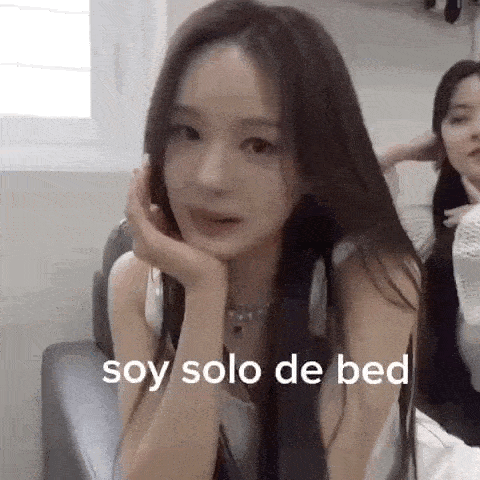 a woman with long hair is sitting in a chair with her hand on her chin and says `` soy solo de bed '' .