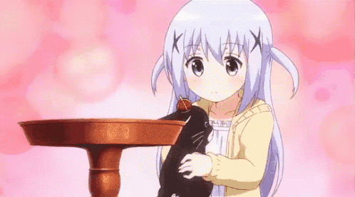 a little girl is holding a black cat in her arms .