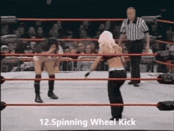 two women are wrestling in a ring with a referee in the background .