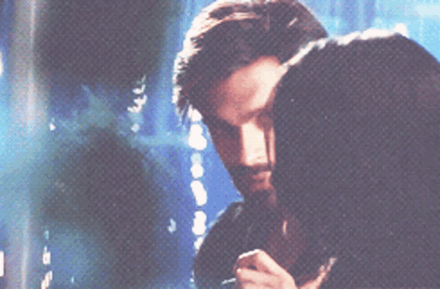 a close up of a man and woman kissing