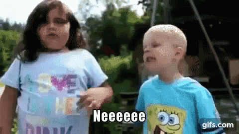 a boy and a girl are standing next to each other and the boy is wearing a spongebob t-shirt .