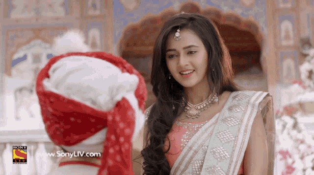 a woman is smiling in front of a sony liv logo