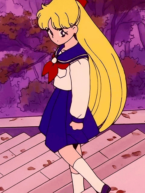 a girl with long blonde hair is wearing a sailor outfit