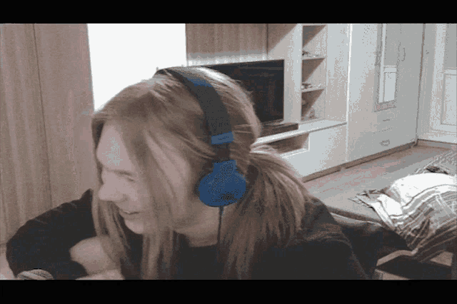 a person wearing a pair of blue headphones that say sony on them