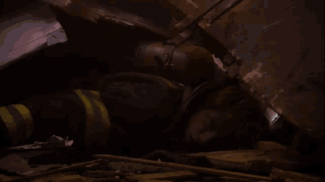 a firefighter is laying on the ground in a collapsed building
