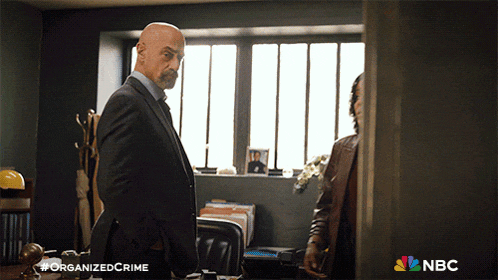 a poster for organized crime shows two men in suits