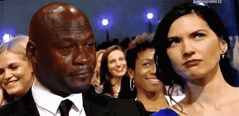 a man in a suit and tie is crying in front of a woman in a dress .