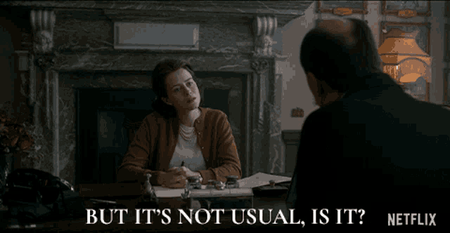 a woman sitting at a desk talking to a man with the words but it 's not usual is it netflix