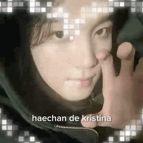 a close up of a person 's face with the words haechan de kristina above it .