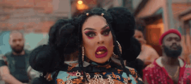 a drag queen with a lot of makeup on her face