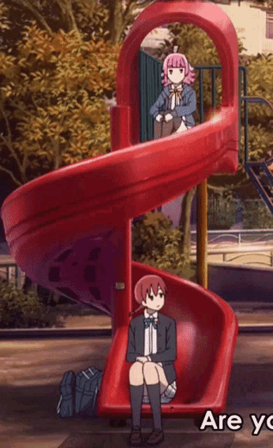 a girl sits on a red slide with the words are you written below her