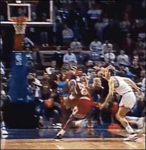 a basketball game is being played in front of a crowd and a player with the number 23 on their back