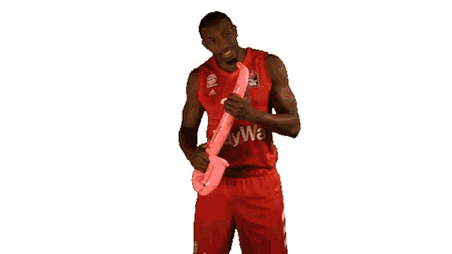 a man in a red jersey that says baywa is playing a saxophone