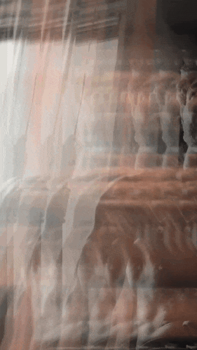 a blurred image of a man 's face with a few other faces