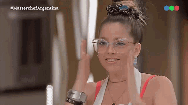 a woman wearing glasses and a red top is on a masterchef argentina show