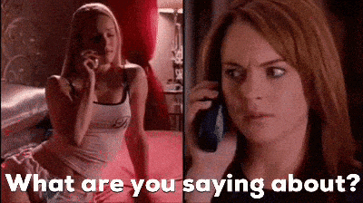 a woman is talking on a cell phone and another woman is talking on a cell phone .
