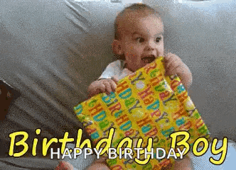 a baby is sitting on a bed holding a birthday present and says happy birthday