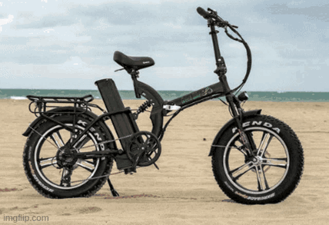 a kenda bicycle is parked on a beach