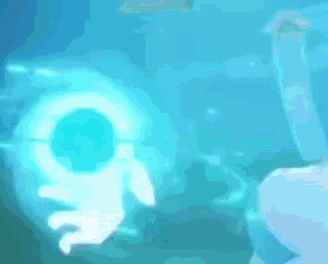 a person is holding a blue object that looks like a circle