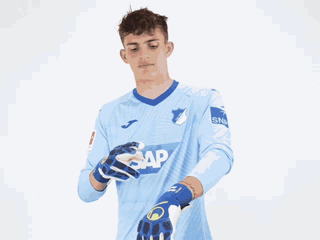 a soccer player wearing a light blue shirt that says sap
