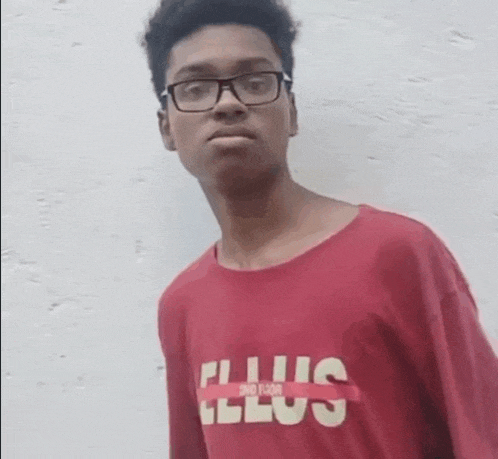 a young man wearing glasses and a red shirt that says " plus " on it