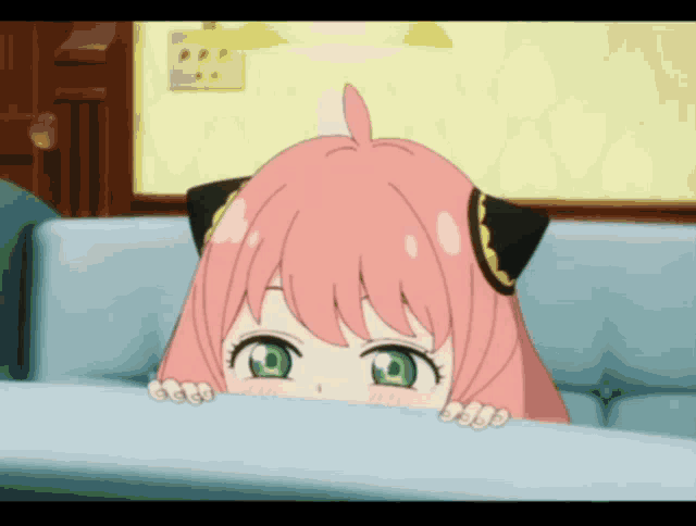 a girl with pink hair and green eyes looks over a table