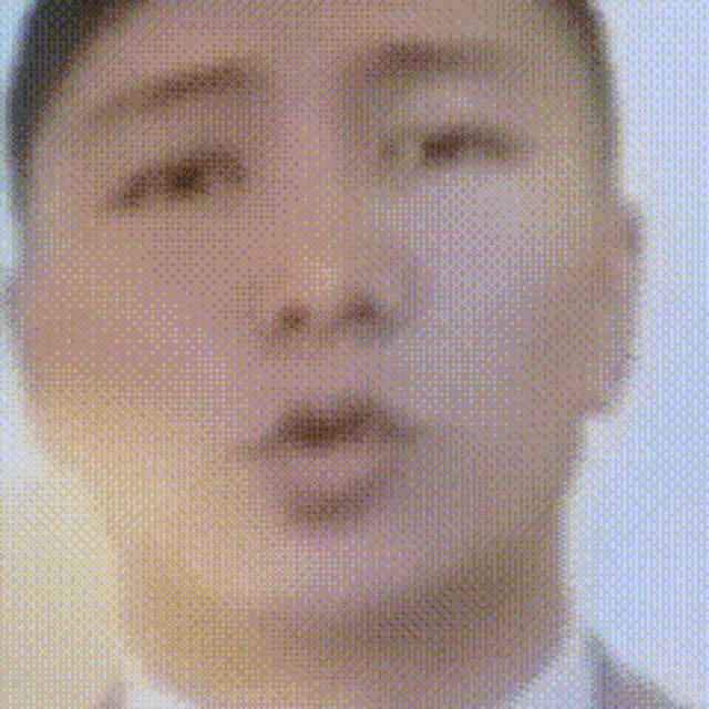 a man in a suit and tie is making a funny face .
