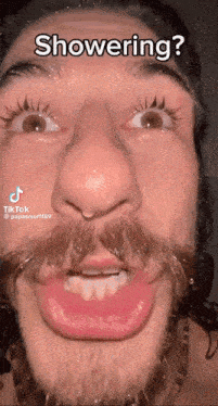 a man with a beard is making a funny face while showering