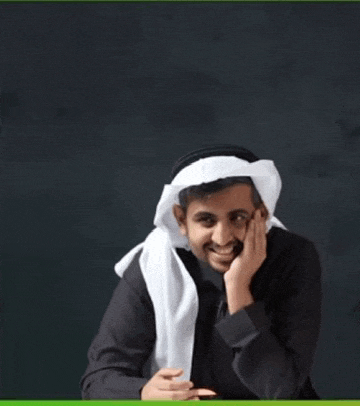 a man wearing a black shirt and a white head scarf smiles with his hand on his chin