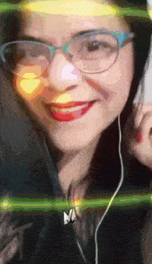 a woman wearing glasses and ear buds is smiling