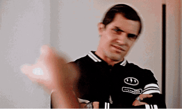 a blurry picture of a man wearing a black jacket with a white circle on it that says ' dirty dancing '