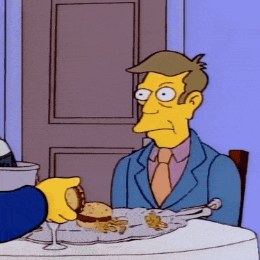 a cartoon of a man sitting at a table with a hamburger and french fries on it