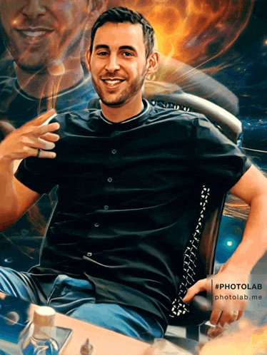 a man in a black shirt is sitting in a chair with his hands on his hips in front of a painting that says photolab