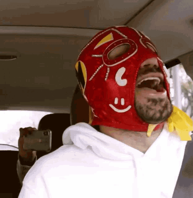a man wearing a red mask with a smile on it