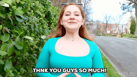 a woman says thank you guys so much in front of a bush