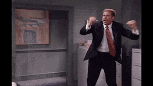 a man in a suit and tie is dancing