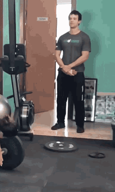 a man standing in a gym wearing a shirt that says ' o'neill ' on it