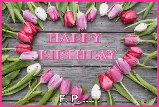 a happy birthday card with pink and white tulips on a wooden background .