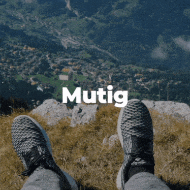 a person laying on a mountain with the word mutig above them