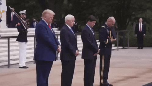 a group of men in suits and military uniforms are standing next to each other