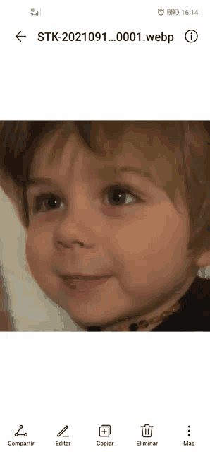 a child 's face is displayed on a phone screen