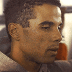 a close up of a man 's face with a serious look on his face