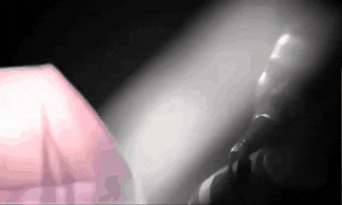 a blurred image of a person talking on a phone in a dark room