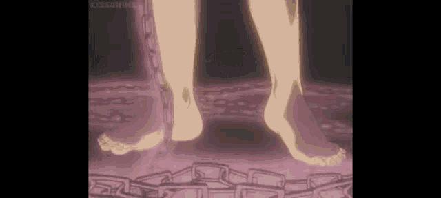 a close up of a person 's feet chained to a chain in a dark room .