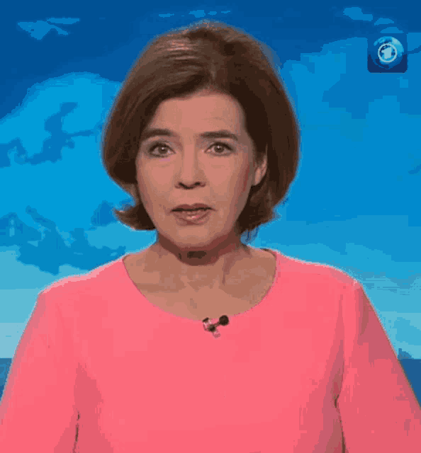 a woman in a pink shirt with the word wyld on it