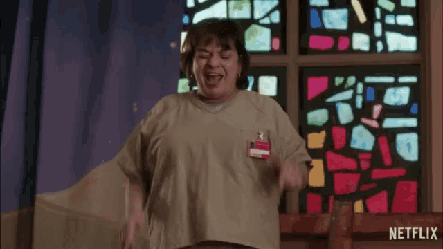 a woman is dancing in front of a stained glass window that says netflix on it
